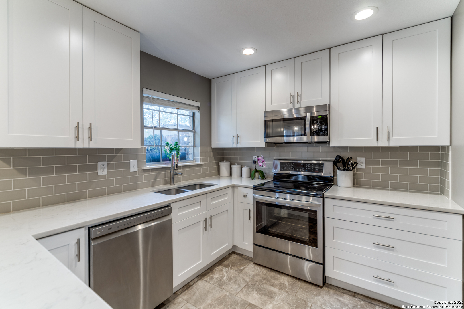a kitchen with stainless steel appliances granite countertop a stove and a sink