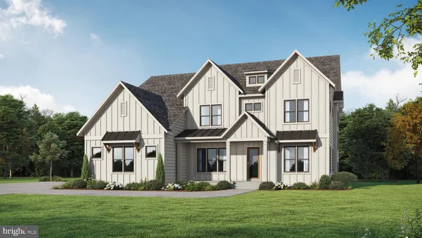 a front view of a house with a yard and trees