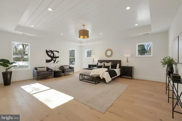 a living room with furniture a fireplace and a chandelier