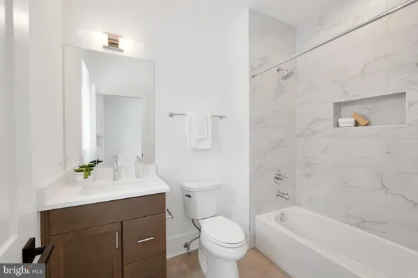 a spacious bathroom with a double vanity sink tub and mirror