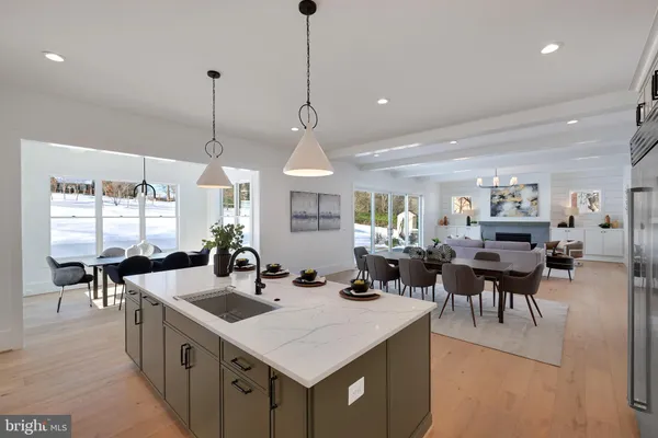 a kitchen with stainless steel appliances kitchen island granite countertop a sink a stove and refrigerator