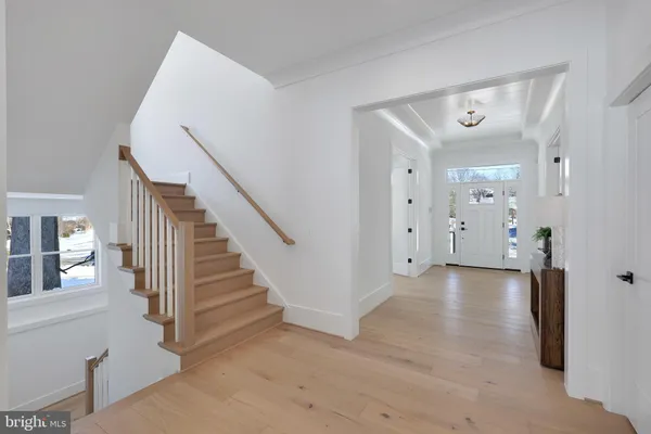 a kitchen with a stove a refrigerator and a dining table with wooden floor