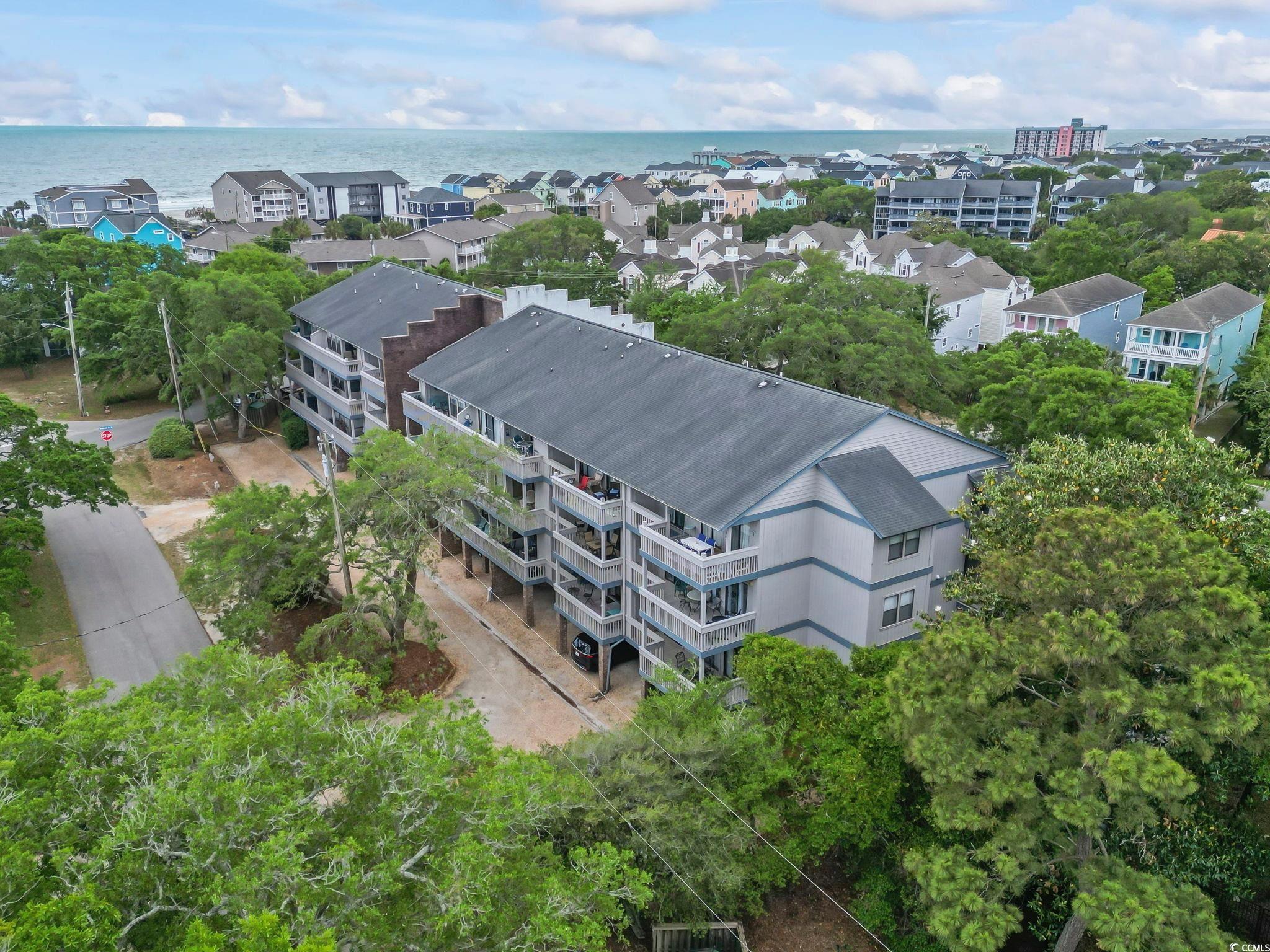 Drone / aerial view of apartment complex and a nearby body of water