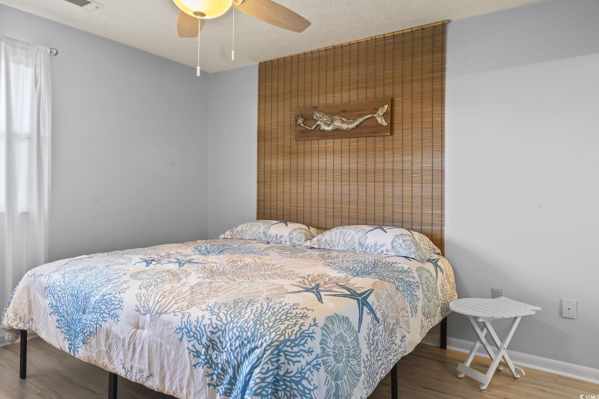 310 5th Avenue North, Unit 206 Surfside Beach, SC 29575 - Photo 15 of 40 Bedroom featuring wood finished floors, ceiling fan, and a textured ceiling