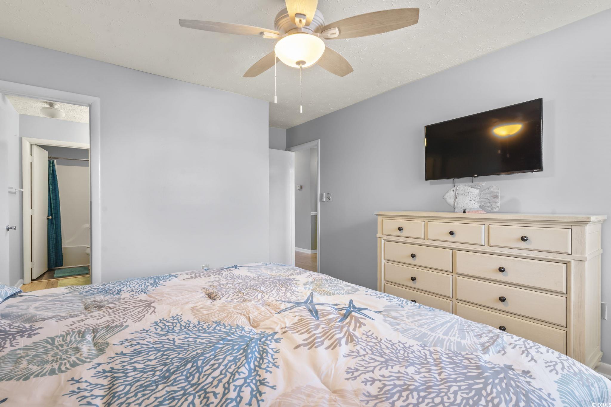 310 5th Avenue North, Unit 206 Surfside Beach, SC 29575 - Photo 16 of 40 Bedroom with ensuite bathroom and ceiling fan