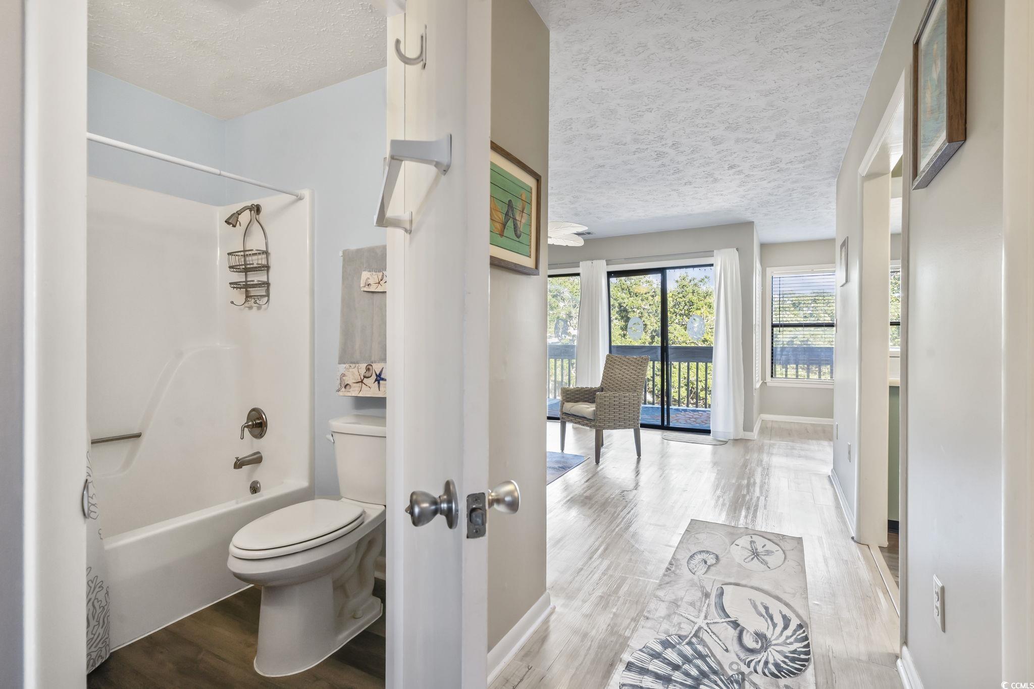 310 5th Avenue North, Unit 206 Surfside Beach, SC 29575 - Photo 23 of 40 Full bathroom featuring shower / bathtub combination, wood finished floors, and a textured ceiling