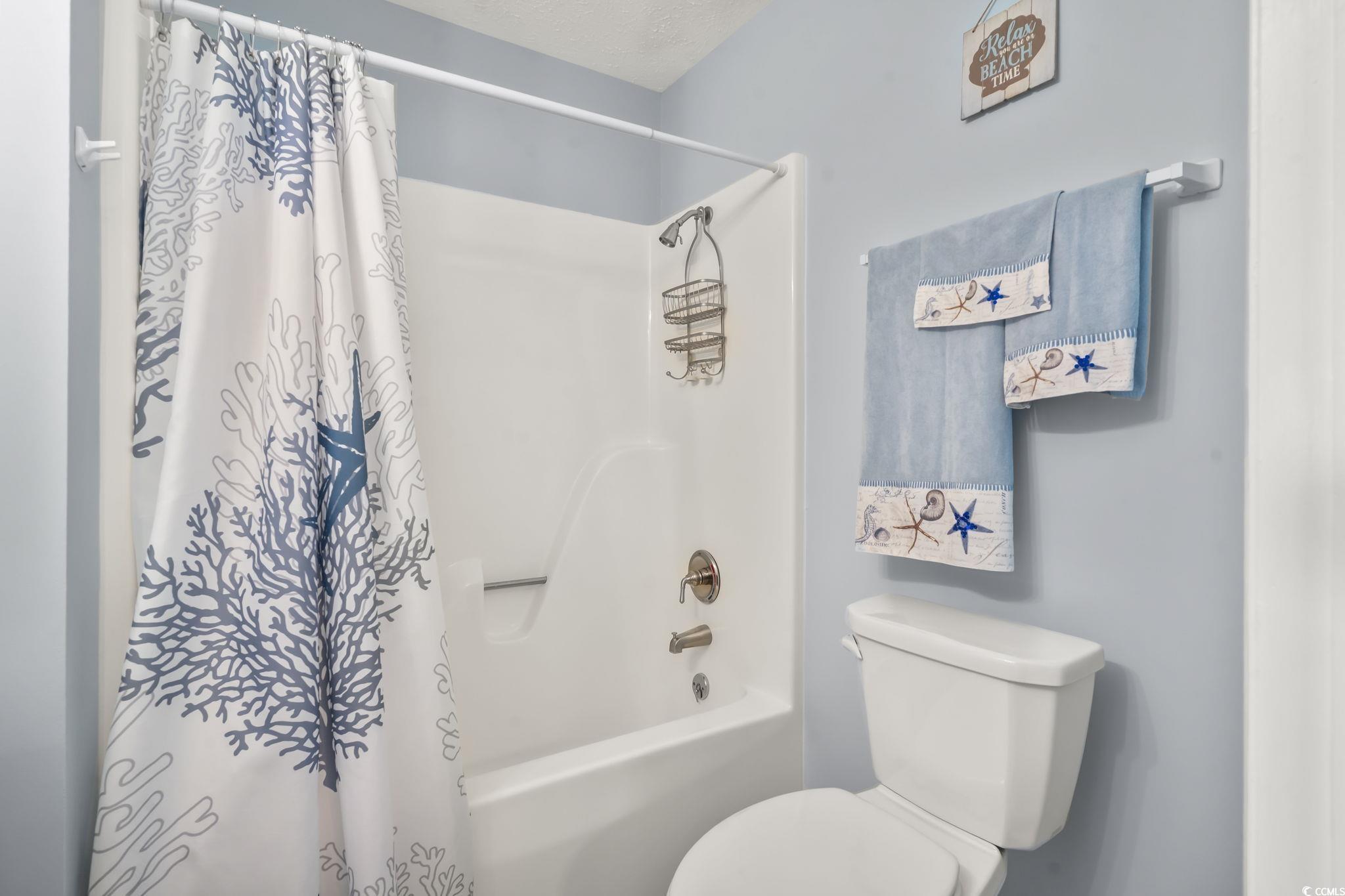 310 5th Avenue North, Unit 206 Surfside Beach, SC 29575 - Photo 24 of 40 Bathroom featuring shower / bath combo with shower curtain and toilet