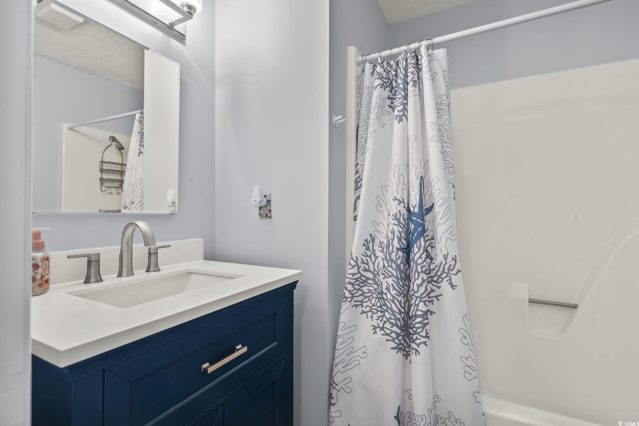 310 5th Avenue North, Unit 206 Surfside Beach, SC 29575 - Photo 25 of 40 Bathroom featuring vanity and shower / bathtub combination with curtain