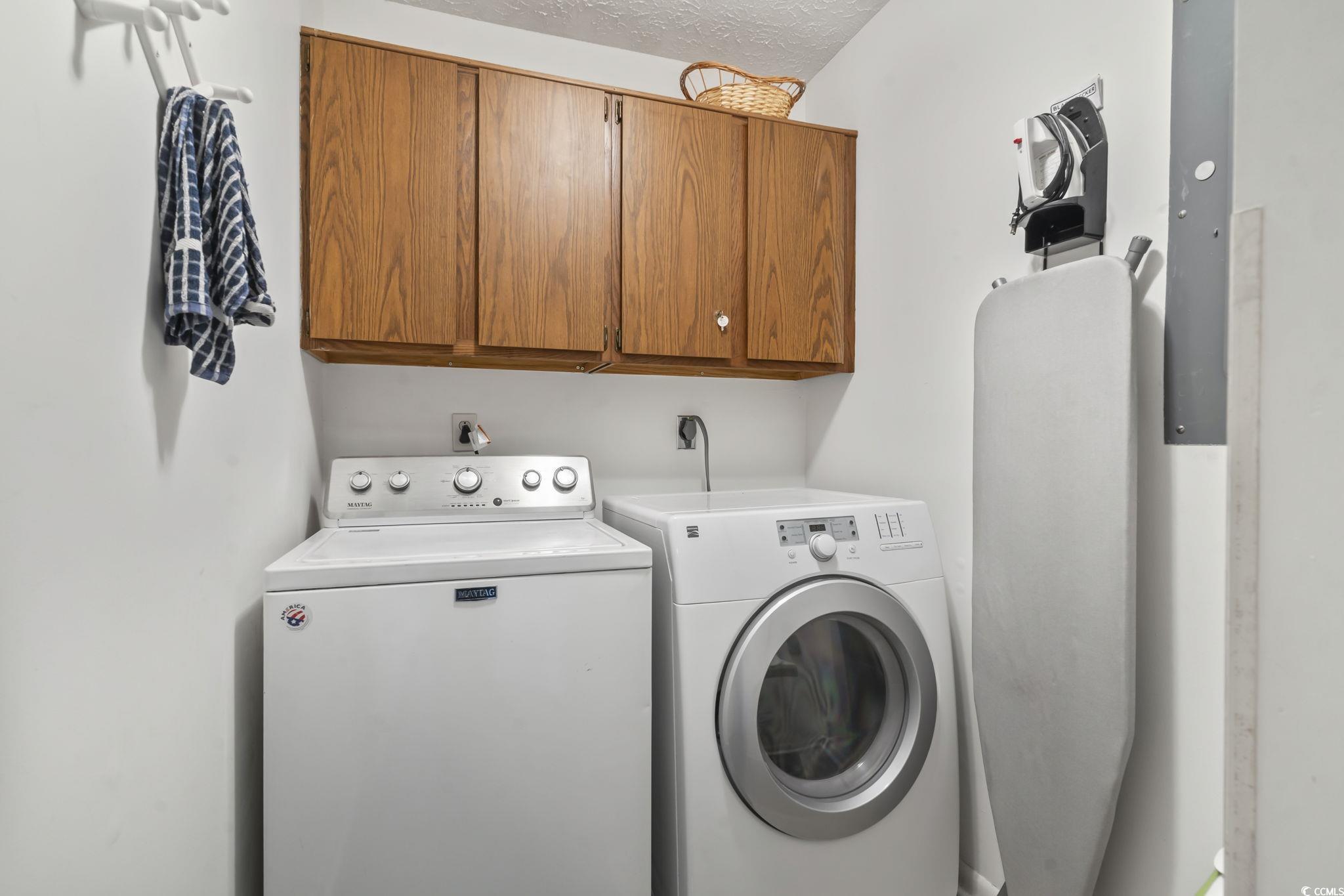 310 5th Avenue North, Unit 206 Surfside Beach, SC 29575 - Photo 34 of 40 Laundry room featuring cabinet space, a textured ceiling, separate washer and dryer, and electric panel