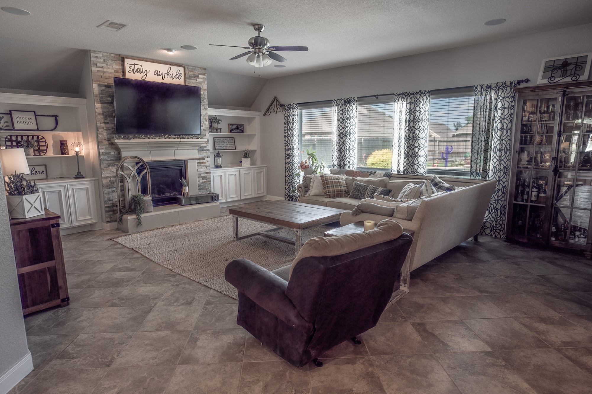 1283 Laurel Lane Angleton, TX 77515 - Photo 10 of 40 Family Room w/Built-in Cabinets & Shelving around the Stone Fireplace.