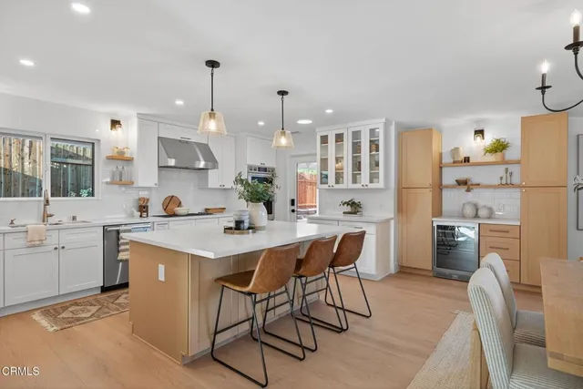 a kitchen with cabinets appliances a sink and a counter top space