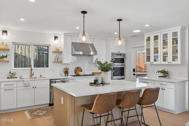 a kitchen with white cabinets and a stove