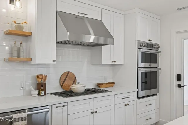 a kitchen with stainless steel appliances a sink stove and refrigerator