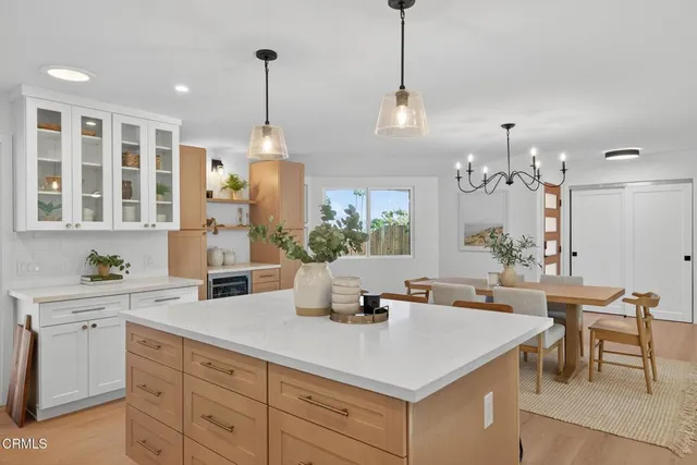 a view of a dining room with furniture wooden floor and chandelier