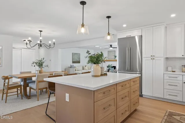 a kitchen with stainless steel appliances a refrigerator and a stove