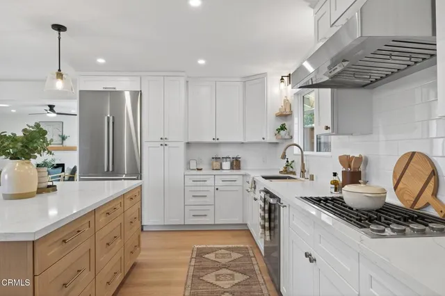 a view of a hallway with wooden floor and closet