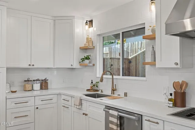 a living room with a bed furniture and a window