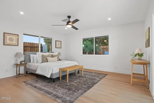 a spacious bedroom with a bed and a potted plant
