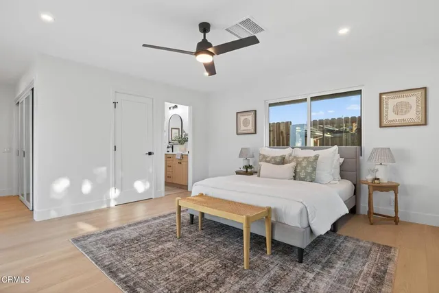 a spacious bedroom with a bed and a rug