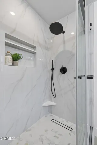 a bath room with a toilet and a shower curtain
