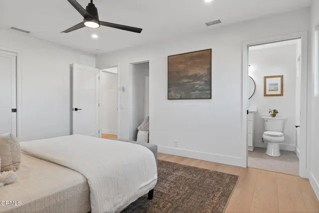a backyard of a house with barbeque oven table and chairs
