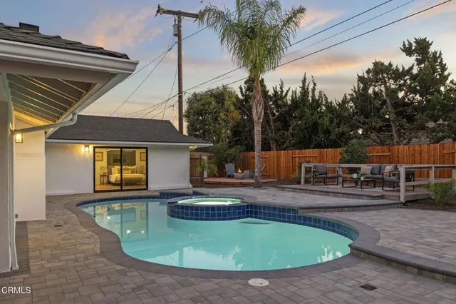 a swimming pool with outdoor seating and yard