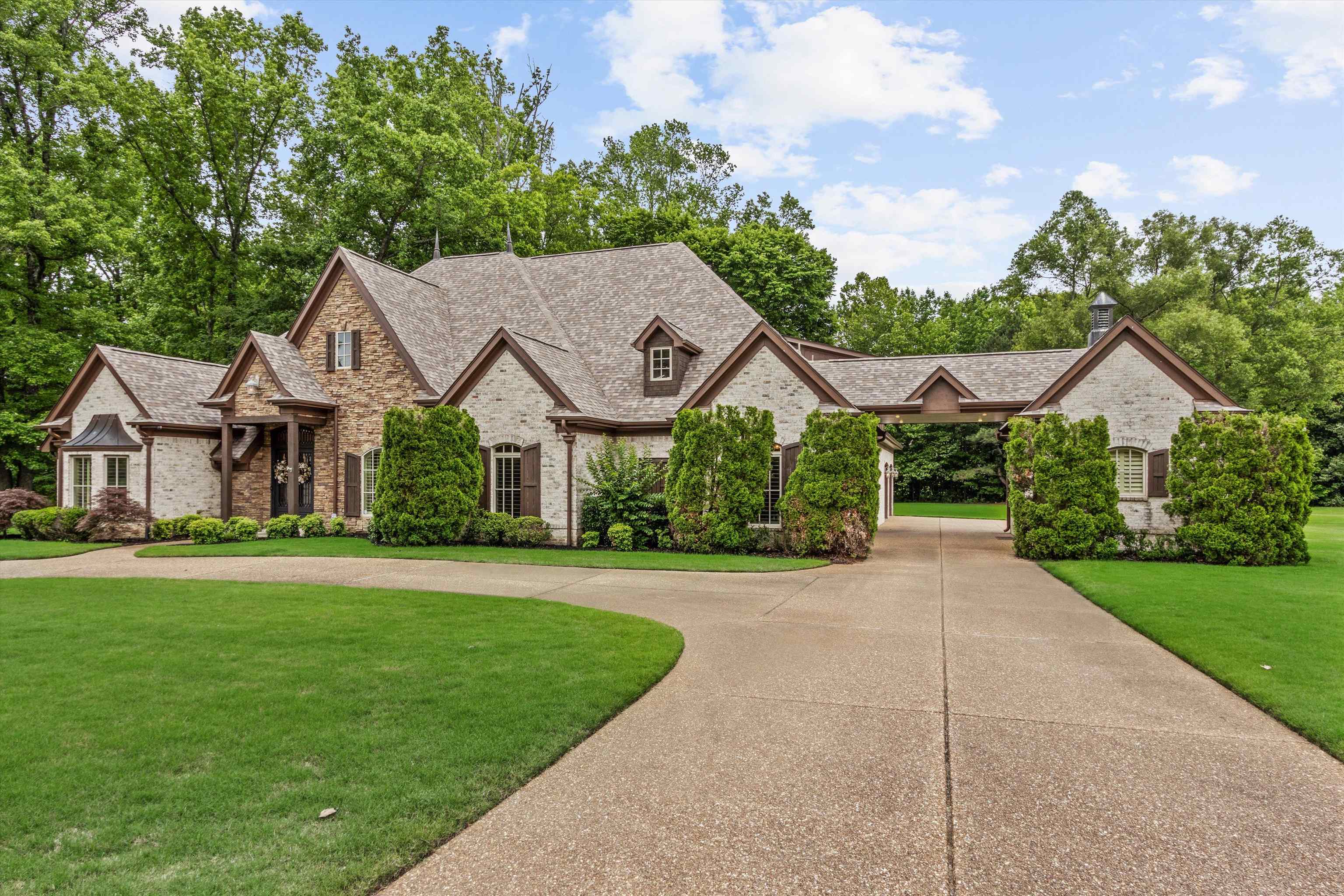 150 Ridgecrest Drive Arlington, TN 38002 - Photo 3 of 40 Stone and brick exterior with a multi-gabled roofline