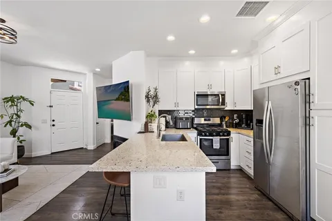 a kitchen with a refrigerator a stove top oven a sink and dishwasher