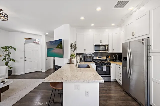 a kitchen with a refrigerator a stove top oven a sink and dishwasher