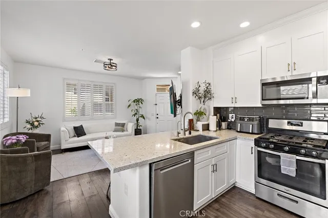 a kitchen with a stove a sink and a refrigerator