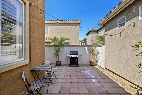 a view of balcony with two chairs and a potted plant