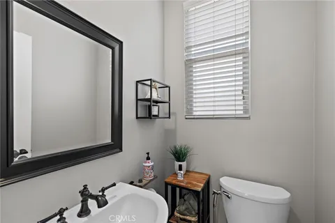 a bathroom with a toilet a sink and a mirror