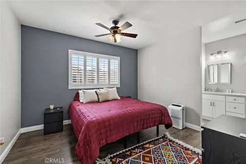 a bedroom with a bed a chandelier and a window