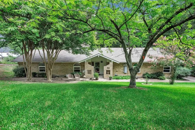 a front view of a house with a garden