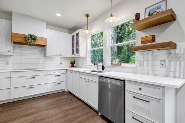 a kitchen with a sink window and cabinets