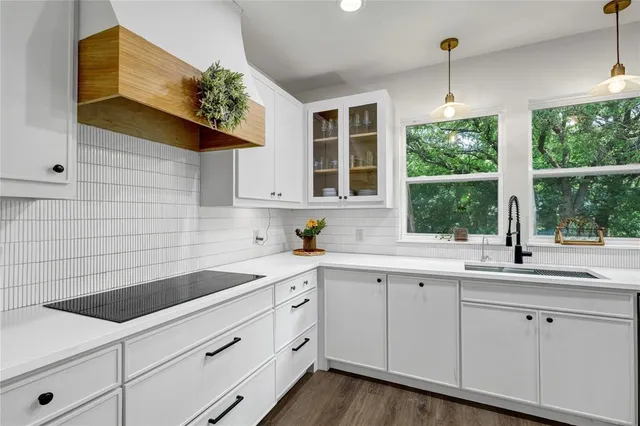 a kitchen with a sink cabinets and window