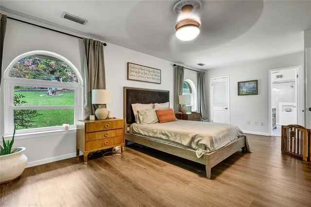 a spacious bedroom with a bed and a large window