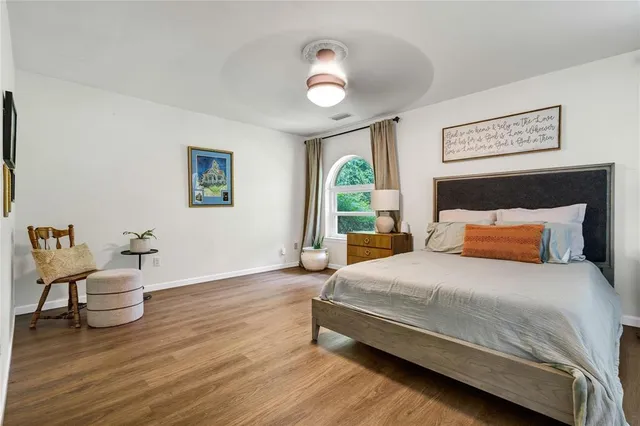 a bedroom with a bed and a chandelier