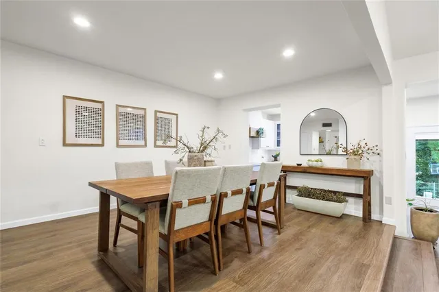 a view of a a dining room with furniture window and wooden floor