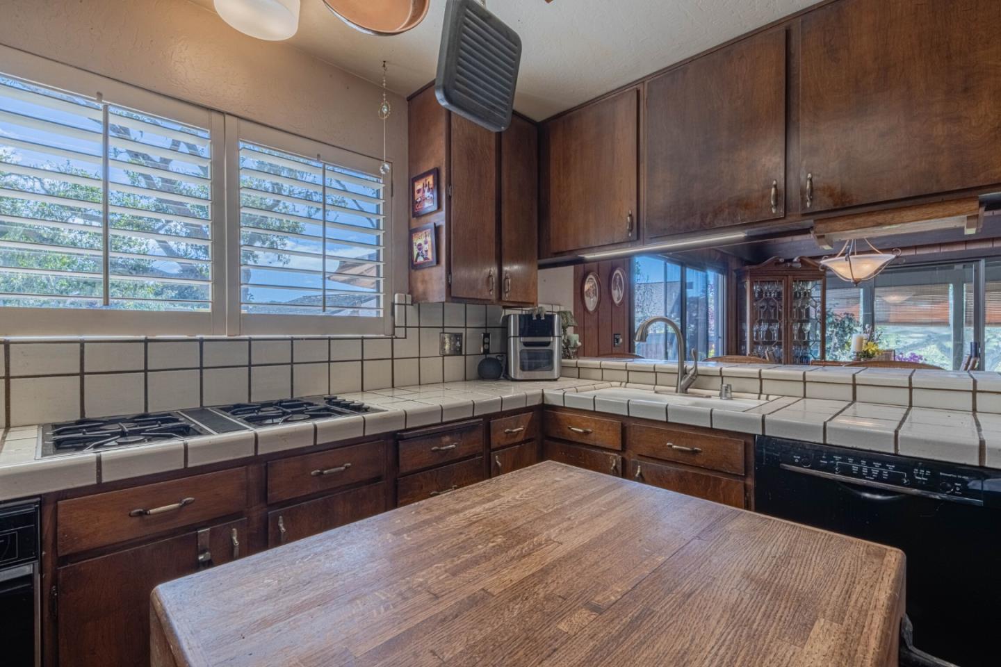 14190 Reservation Road Salinas, CA 93908 - Photo 13 of 34 a kitchen with granite countertop a sink and a stove