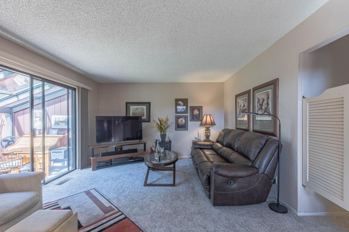 14190 Reservation Road Salinas, CA 93908 - Photo 16 of 34 a living room with furniture and a flat screen tv
