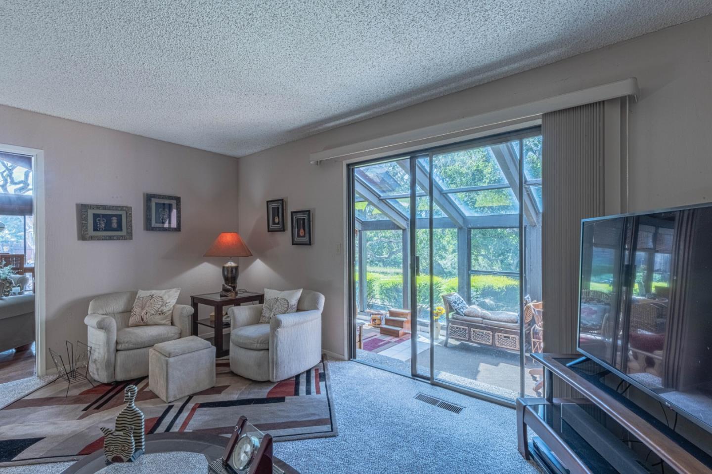 14190 Reservation Road Salinas, CA 93908 - Photo 17 of 34 a living room with furniture and a floor to ceiling window