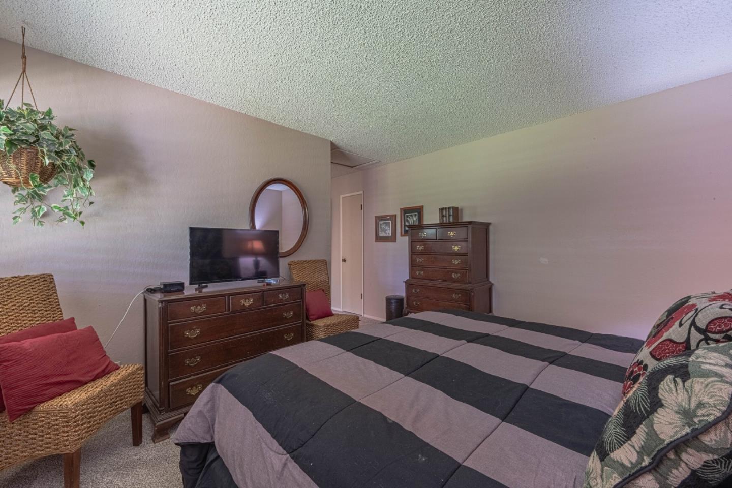 14190 Reservation Road Salinas, CA 93908 - Photo 22 of 34 a bedroom with a bed and a dresser