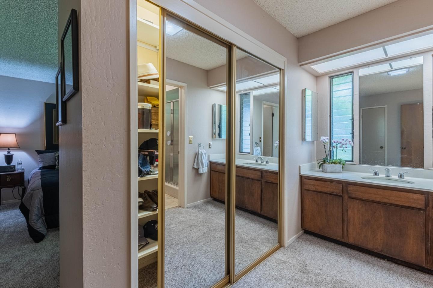 14190 Reservation Road Salinas, CA 93908 - Photo 24 of 34 a bathroom with a double vanity sink and a mirror