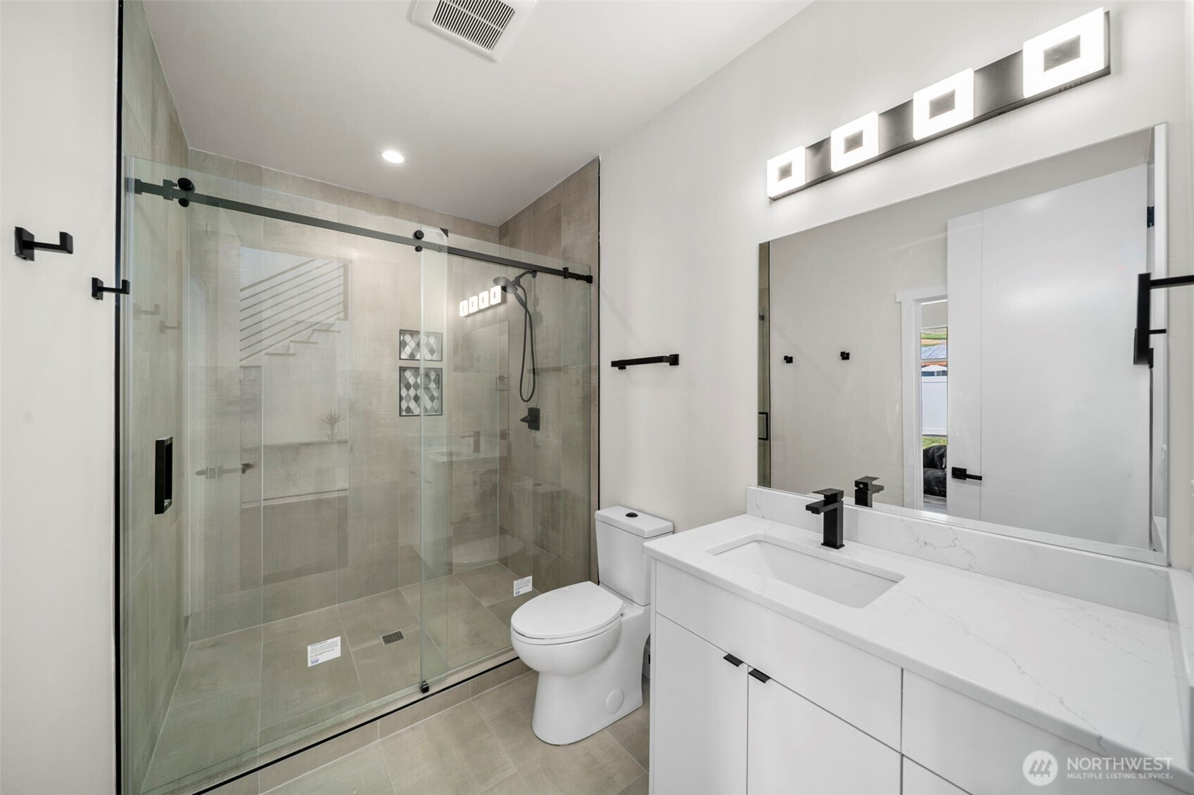 83 Summerset Boulevard Manson, WA 98831 - Photo 11 of 40 a bathroom with a shower sink mirror and toilet