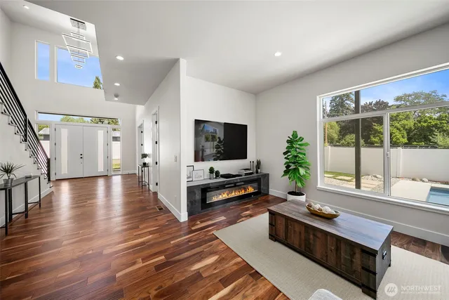 a living room with furniture wooden floor and a flat screen tv