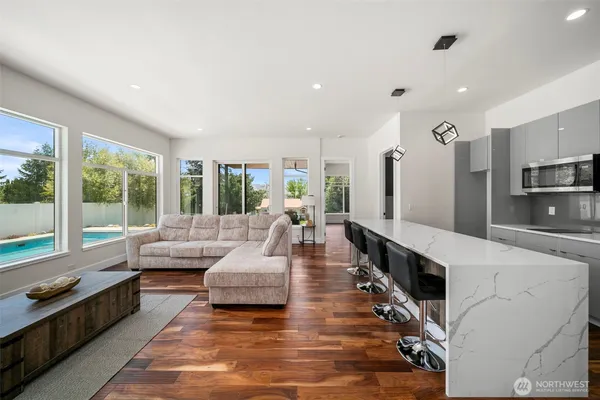 a living room with fireplace furniture and a large window