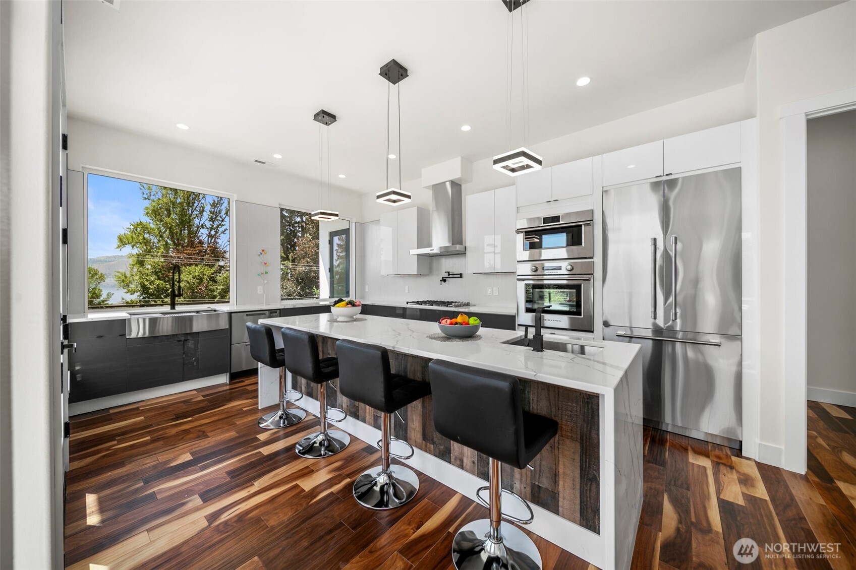 83 Summerset Boulevard Manson, WA 98831 - Photo 20 of 40 a kitchen with stainless steel appliances a stove a refrigerator and a fireplace