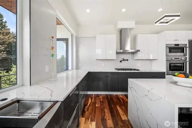 a kitchen with kitchen island granite countertop a sink stove and refrigerator