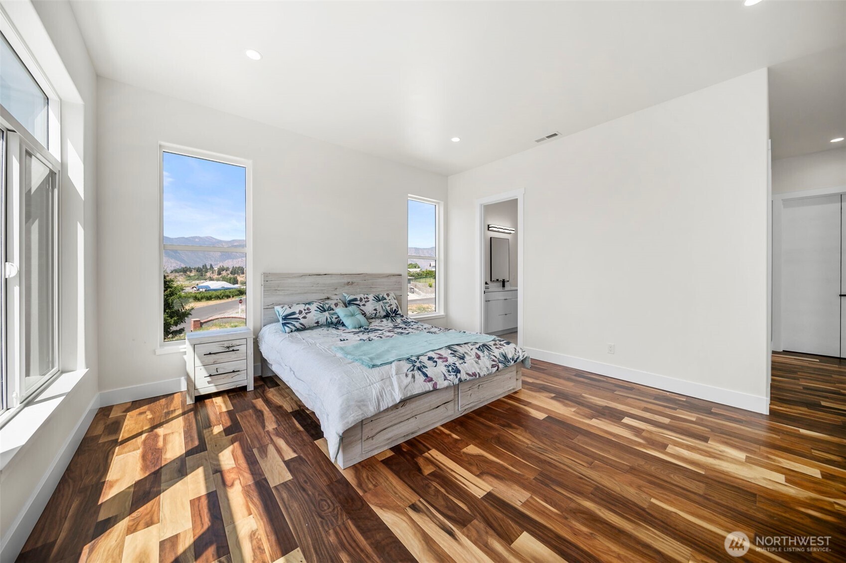 83 Summerset Boulevard Manson, WA 98831 - Photo 23 of 40 a bedroom with a bed and wooden floor